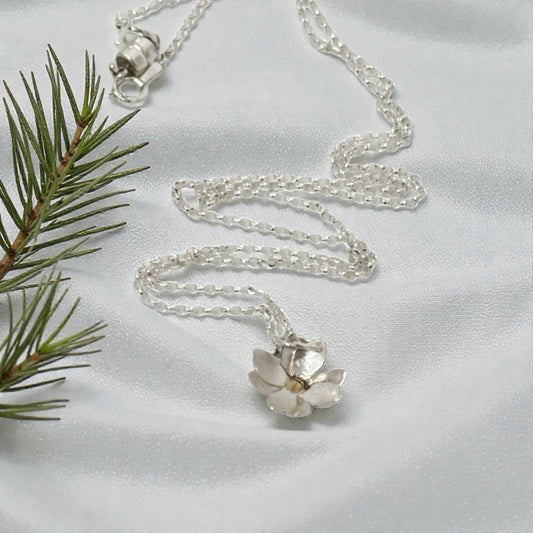 Sterling silver and 18kt gold Wild Rose pendant necklace by Aprilierre featuring a delicate floral design.