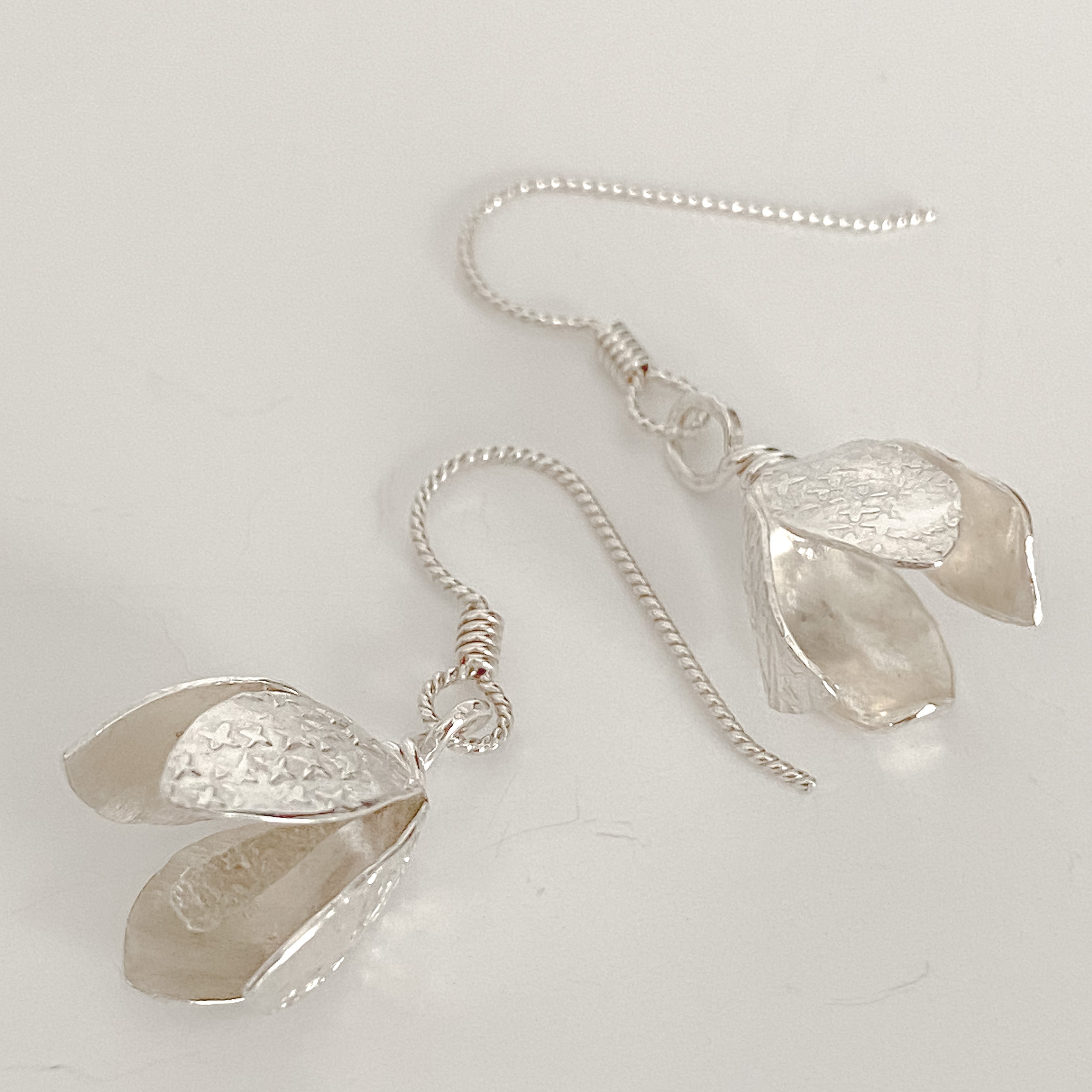 Genuine miniature flowers, set in sterling silver, available at natur