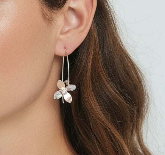 Sterling silver earrings with white topaz gemstones from Aprilierre's Eloquent Petals collection, displayed on a white background.